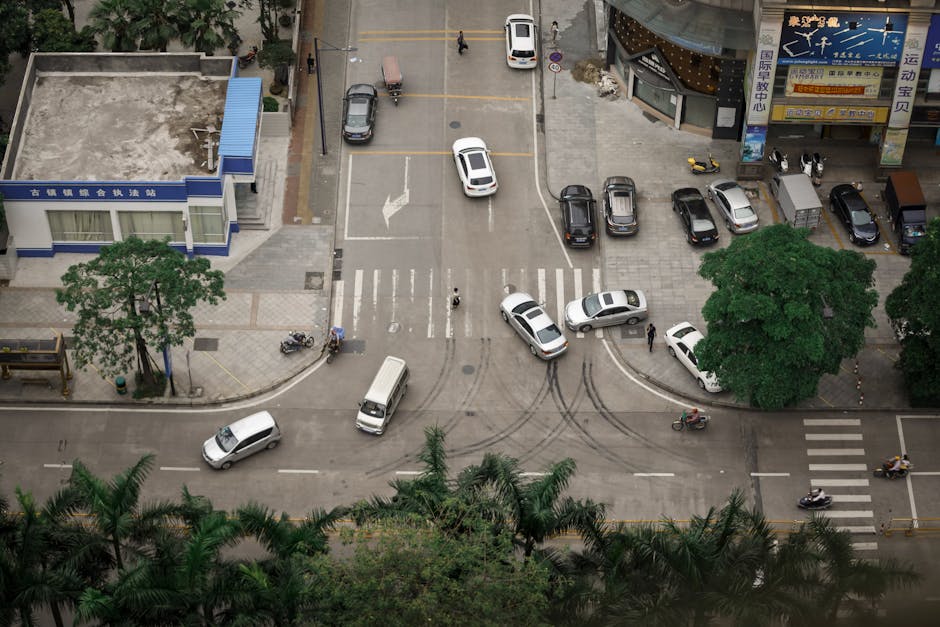 A car making an improper turn at a traffic light, nearly striking a pedestrian