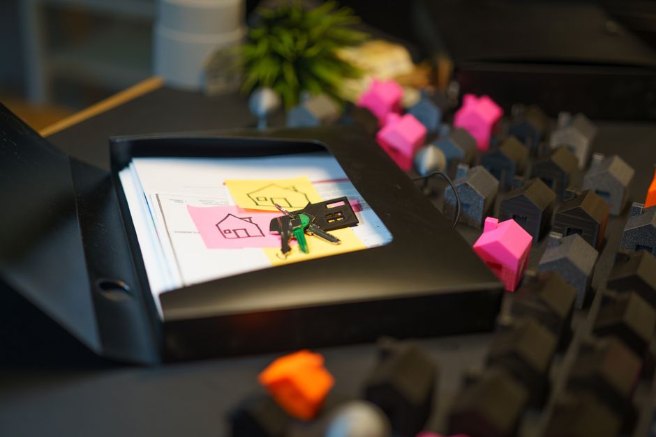 Property deed preparation documents on a desk with pen and keys